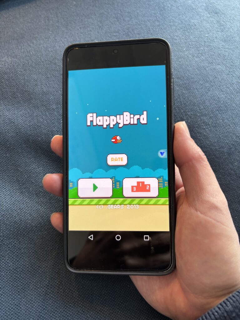 The title screen of viral mobile game Flappy Bird, shown on a mobile phone.